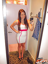 Standing in changing room long hair wearing dress hand on hip taking selfie