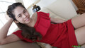 Mee on sofa wearing red dress