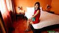 Sitting on bed wearing dress